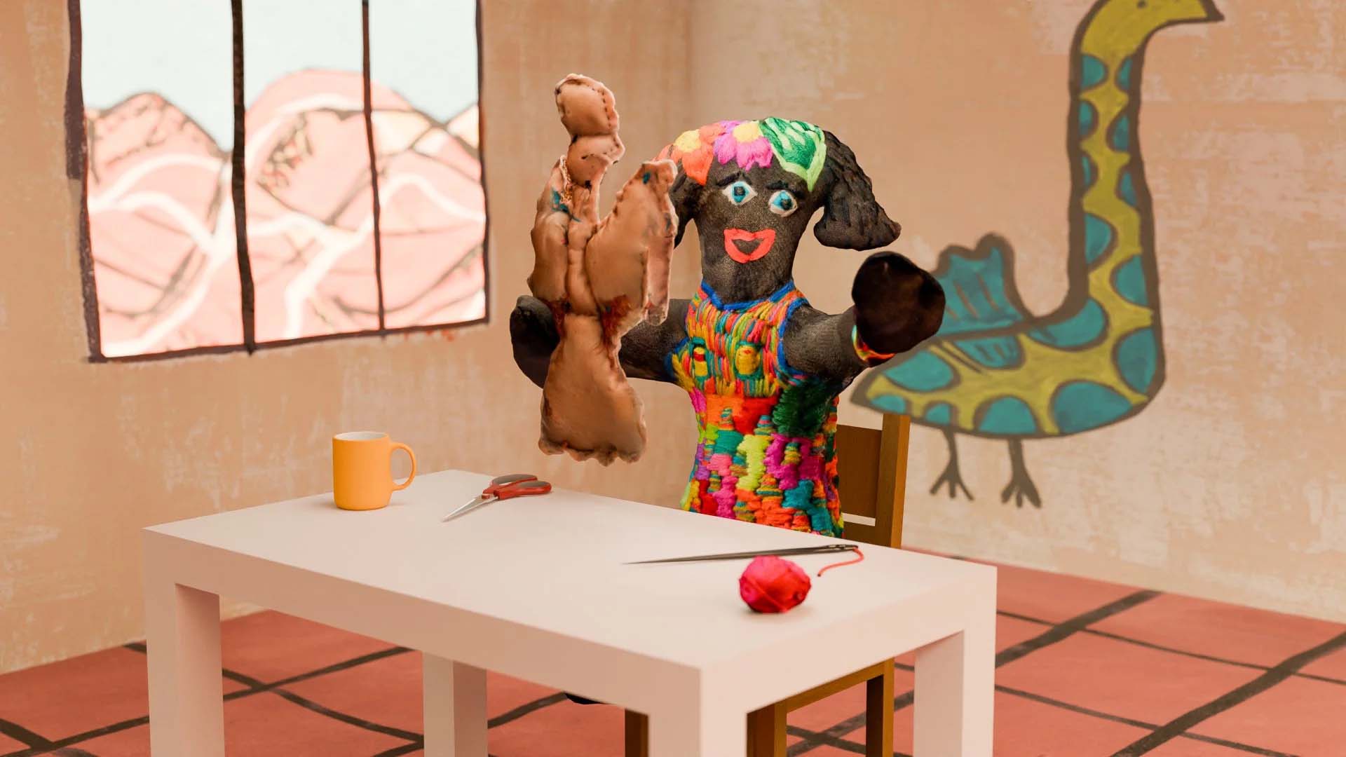 Colorful puppet sitting at a table, holding a brown stuffed toy. Scissors, yarn, and a mug on the table; mural of a bird on the wall.